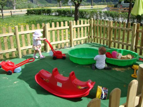 two children playing with toys in a sandbox at Gästehaus Schwoagerhof in Fügen