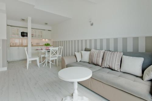 a living room with a couch and a table at Apartamenty Gdańsk EU - Waterlane in Gdańsk
