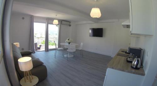 a living room with a couch and a table at Maison Carles BnB in La Colle-sur-Loup