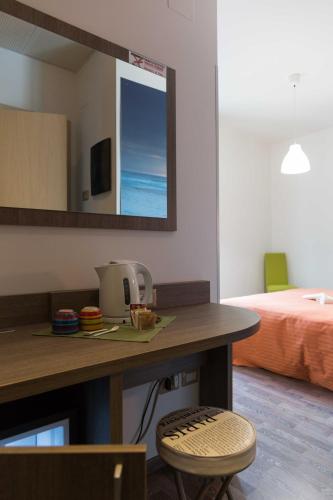 a room with a table and a bedroom with a bed at Hotel Miramare in Pineto