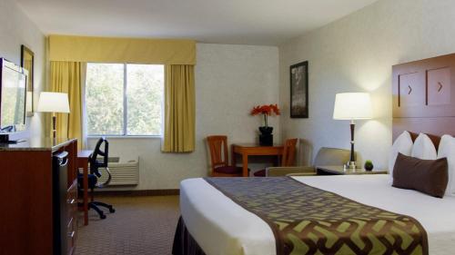 a hotel room with a bed and a desk at Moab Valley Inn in Moab