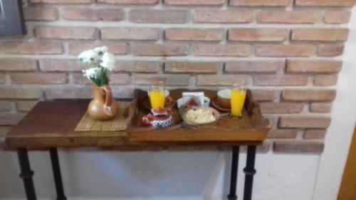 a table topped with plates of food and drinks at Hostal Tierra de Vinos in Cafayate