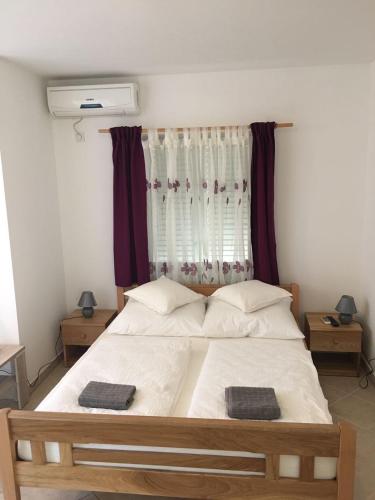a bedroom with a bed with two towels on it at Apartment Patrizia in Zadar