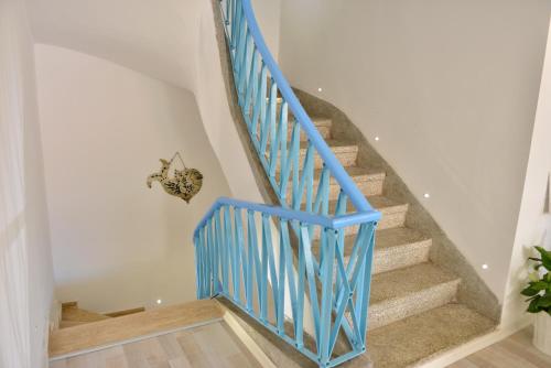 a staircase with blue railings in a house at Minu Hotel in Fethiye