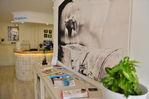 a room with a table with a picture on the wall at Minu Hotel in Fethiye