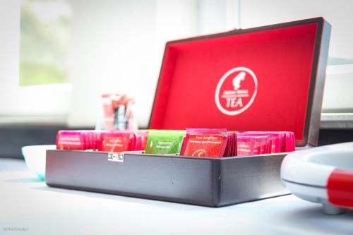 a table with a red box with chinese writing on it at Becar Pyramid Rooms in Visoko