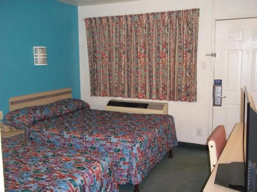 a hotel room with a bed and a window at Skyline Inn in Conway