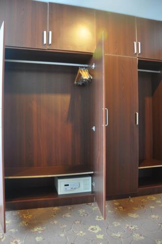 a wooden cabinet with a dvd player in it at King Parkview Hotel in Beijing