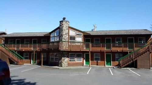 a large apartment building with a balcony and parking lot at Harborview Inn in Seward