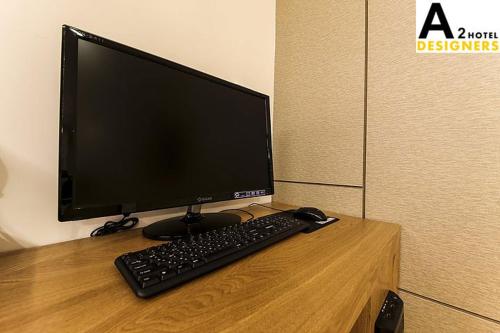 a computer monitor and a keyboard on a desk at A2 Hotel Desingers in Yesan
