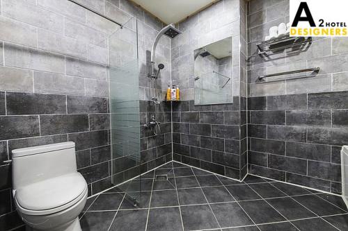 a bathroom with a white toilet and a shower at A2 Hotel Desingers in Yesan