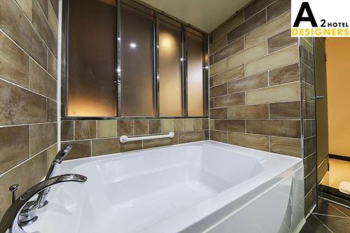 a large white bath tub in a bathroom at A2 Hotel Desingers in Yesan