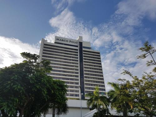 a large building with a masued hub sign on it at Marco Polo Plaza Cebu in Cebu City