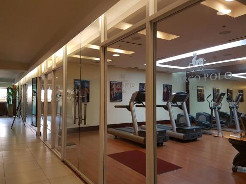 a gym with several tread machines in a room at Marco Polo Plaza Cebu in Cebu City