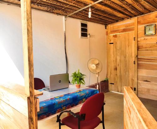 a room with a desk with a laptop on it at Pleasant Park Holiday Inn in Trincomalee