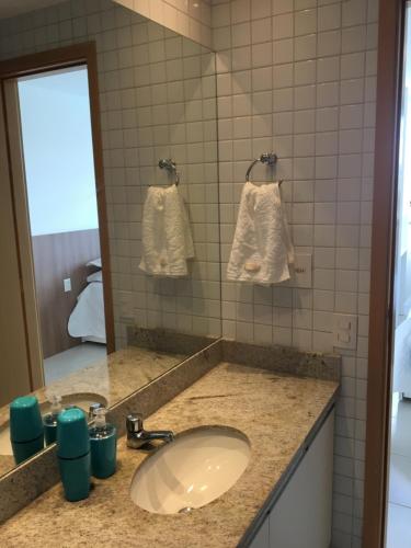 y baño con lavabo y espejo. en Nui Supreme Beach Living, en Porto de Galinhas