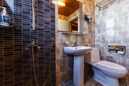 a bathroom with a toilet and a sink at Harmony Resort in Jeju