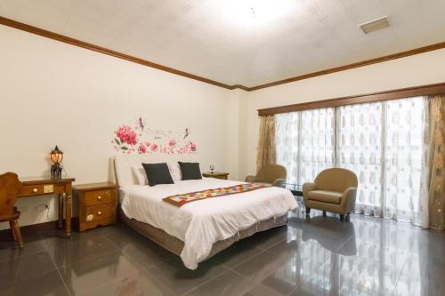 Postel nebo postele na pokoji v ubytování Tainan Yi Home