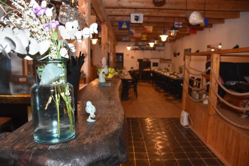 a vase filled with flowers sitting on a table at Farma Noe in Březina