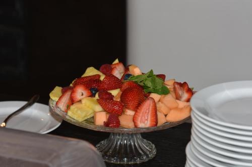 a bowl of strawberries and other fruit on a table at Farma Noe in Březina
