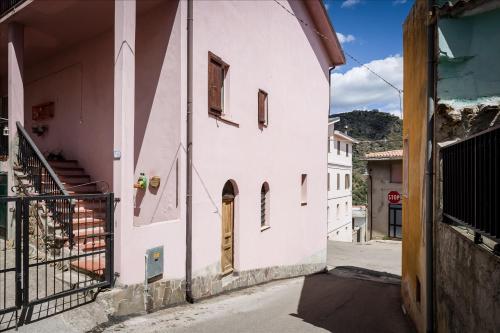an alley in a town with a white building at B&B Gennarcu in Ussàssai