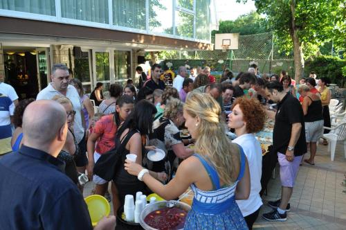 a crowd of people standing outside of a building at Hotel Sandra in Rimini