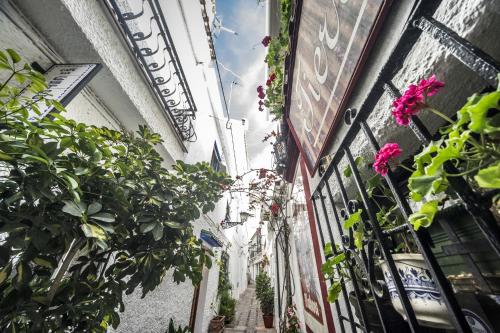 an alley with flowers and plants in a building at Óbal Hotel Marbella in Marbella