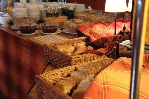 a buffet with baskets of bread and other food at Hotel Hermica in Tampere