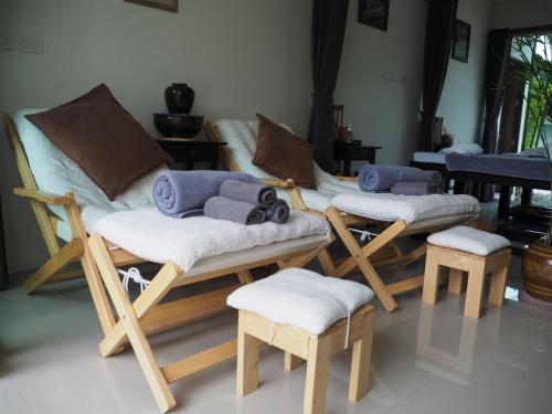 a room with four wooden chairs and a piano at Crystal Lamai Hotel in Lamai