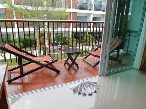 a balcony with two chairs and a table at Crystal Lamai Hotel in Lamai