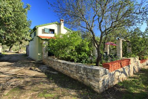 a stone retaining wall in front of a house at Stone House Oreb`s Cottage in Vela Luka