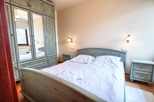 a bedroom with a bed with a dresser and a mirror at ZAKOkrywan in Zakopane
