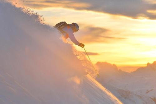 a person is skiing down a snow covered slope at Apart6580 in Sankt Anton am Arlberg