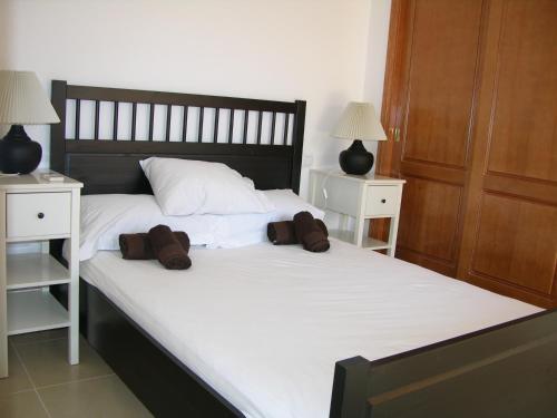 a bedroom with a bed with two night stands and two lamps at Albatros Playa 3 - 1307 in Mar de Cristal