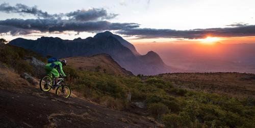 a person riding a bike on a hill at sunset at Apart6580 in Sankt Anton am Arlberg