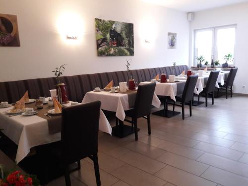 a row of tables and chairs in a restaurant at Zum alten Bahnhof in Blunk