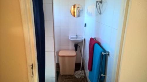 a small bathroom with a sink and a toilet at Furnished self-catering bedsitter in Lusaka