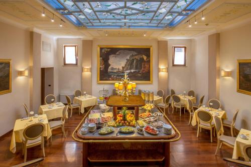 a dining room with a table with food on it at La Residenza in Rome