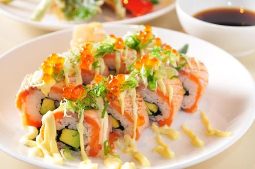 a plate of food with sushi on a table at Brother Hotel in Taipei
