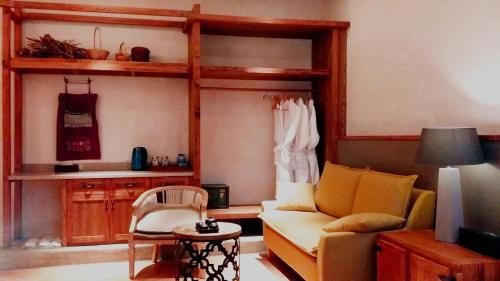 a living room with a couch and a table at The Twelve Manor•Terraces Lodge in Yuanyang