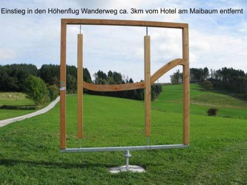 a large metal structure in the middle of a field at Hotel am Maibaum in Neuenrade