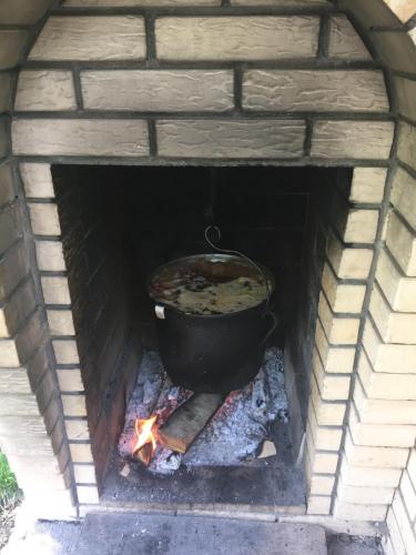 a pot of food cooking in a brick oven at Pensiunea JOJO in Băile Herculane