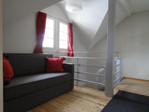 a living room with a couch and a window at Chalet INN in Innsbruck