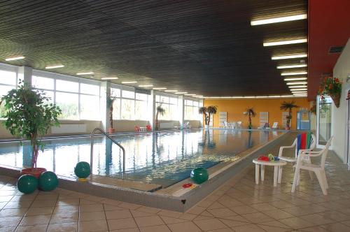 a large swimming pool in a large building at Panoramic Apartments Hohegeiß in Hohegeiß