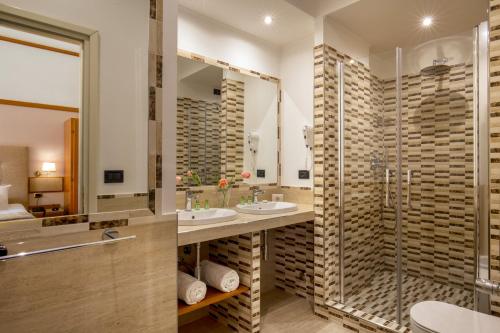 a bathroom with two sinks and a shower at La Residenza in Rome