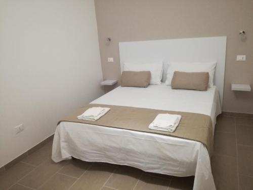 ein Schlafzimmer mit einem großen Bett mit zwei Handtüchern darauf in der Unterkunft Cuore Galateo in Galatone