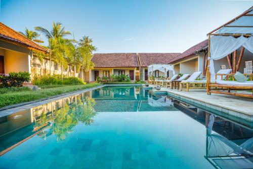 an image of a swimming pool at a villa at Kuta Baru Hotel in Kuta Lombok