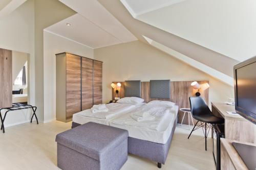Postel nebo postele na pokoji v ubytování Hotel Astor
