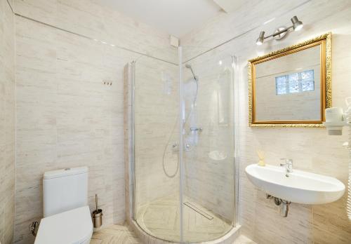 a bathroom with a shower and a toilet and a sink at Apartamenty Łozówka in Zamość