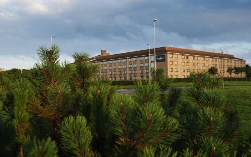 a large building with trees in front of it at The Aberdeen Altens Hotel in Aberdeen